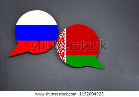 Russia and Belarus flags with two speech bubbles on dark gray background