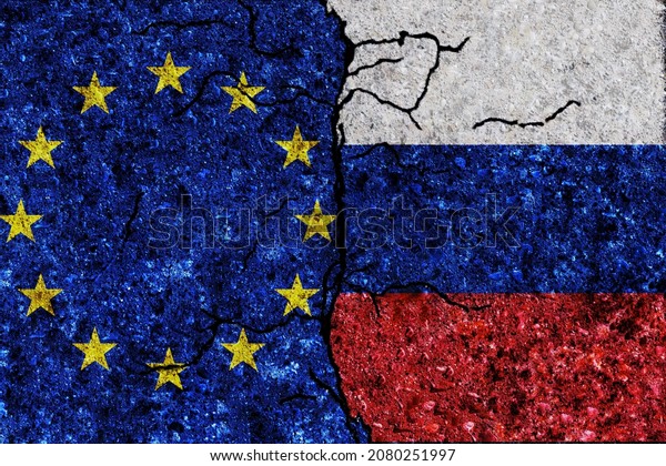 Russia and European Union painted flags on a\
wall with grunge texture. Russia and European Union conflict. EU\
and Russia flags together. Russia vs\
EU