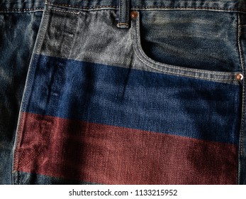 Russia Flag On Jeans Denim Texture With Pride Word. The Concept Of Russia National Flag On Denim Jeans Background. Russia Textile Industry Or Politics Concept.