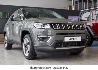 Russia, Izhevsk - March 4, 2022: Jeep showroom. New modern Compass car in dealer showroom. Front and side view. Off-road vehicles. Alliance Stellantis. Famous world brand.