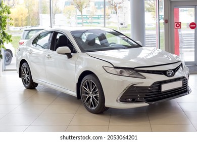 Russia, Izhevsk - September 30, 2021: Toyota Showroom. New Bussines Class Toyota Camry Car In Dealer Showroom. Front And Side View. Famous World Brand. Modern Transportation.