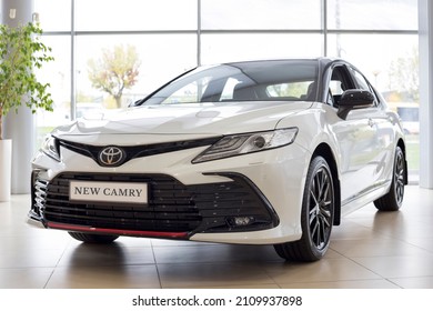 Russia, Izhevsk - September 30, 2021: Toyota Showroom. New Bussines Class Toyota Camry Car In Dealer Showroom. Front And Side View. Famous World Brand. Modern Transportation.