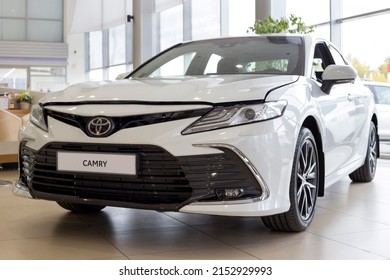 Russia, Izhevsk - September 30, 2021: Toyota Showroom. New Bussines Class Toyota Camry Car In Dealer Showroom. Front And Side View. Famous World Brand. Modern Transportation.