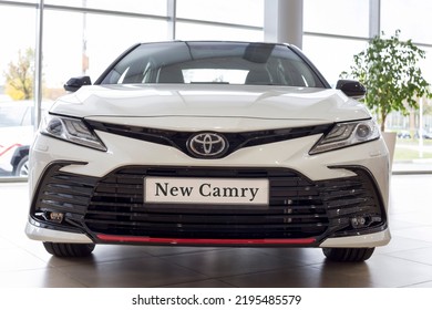 Russia, Izhevsk - September 30, 2021: Toyota Showroom. New Bussines Class Toyota Camry Car In Dealer Showroom. Front View. Famous World Brand. Modern Transportation.