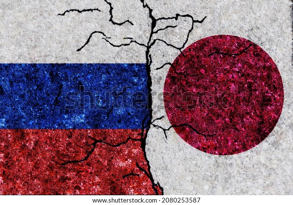 Russia and Japan painted flags on a wall with\
grunge texture. Russia and Japan conflict. Japan and Russia flags\
together. Russia vs\
Japan