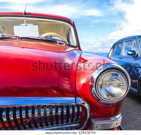 Russia,  Kamchatka - 05 October, 2017: Red vintage\
car GAZ-21 on a festival of old cars on Kamchatka. Retro car\'s\
headlight close up.
