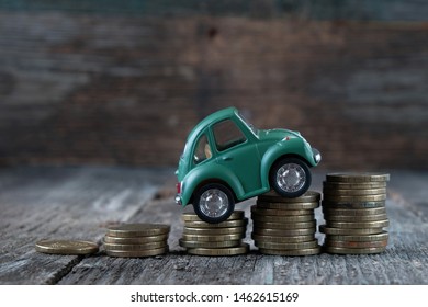 Russia, Kazan: July, 12, 2019. Car Model On  Background Of Coins. Concept Of Leasing, Auto Loan, Auto Insurance, Taxes.