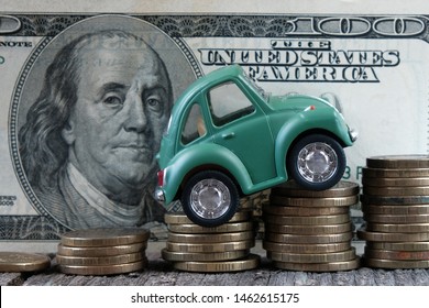 Russia, Kazan: July, 12, 2019.Car Model On  Background Of Coins. Concept Of Leasing, Auto Loan, Auto Insurance, Taxes.