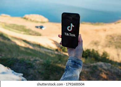 Russia, Kazan May 25 2020: Tiktok Social Media Network. Girl Holds Apple IPhone X With Tik Tok App Icon.