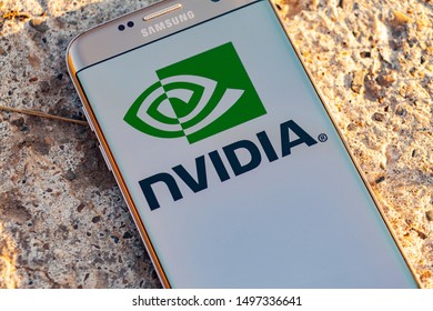 Russia, Kazan Sep 2 2019: Man holding smartphone with Nvidia logo with the finger on the screen