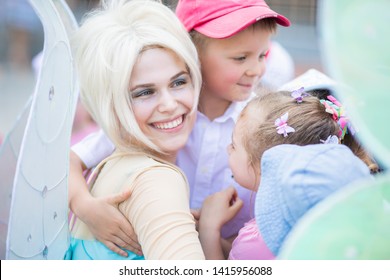 RUSSIA, KRASNODAR - MAY 31 2019: Animators Working At The Birthday Party For Little Children. Happy Kids Hugging With Animator Girl, Dressed Like Tinker Bell Fairy