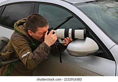 Russia Krasnoyarsk - April 29, 2022 Man Detective
  With A Big Camera Sony Takes Pictures From The Car