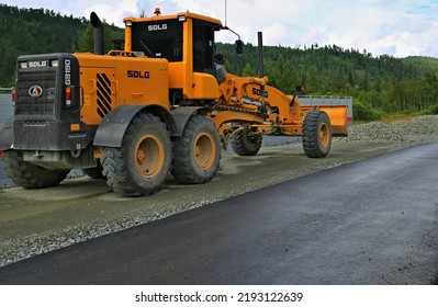 Russia Krasnoyarsk - July 23, 2022 JCB Yellow Grader On The Construction Of The Road Highway New Asphalt