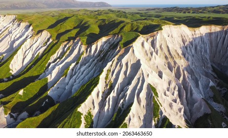 Russia, Kuril Islands, Iturup Island, White rocks on the coast of the Sea of Okhotsk. Aerial view. Soft focus. - Shutterstock ID 2063463650