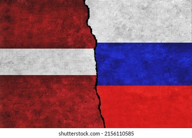 Russia and Latvia painted flags on a wall with a crack. Russia and Latvia conflict. Latvia and Russia flags together