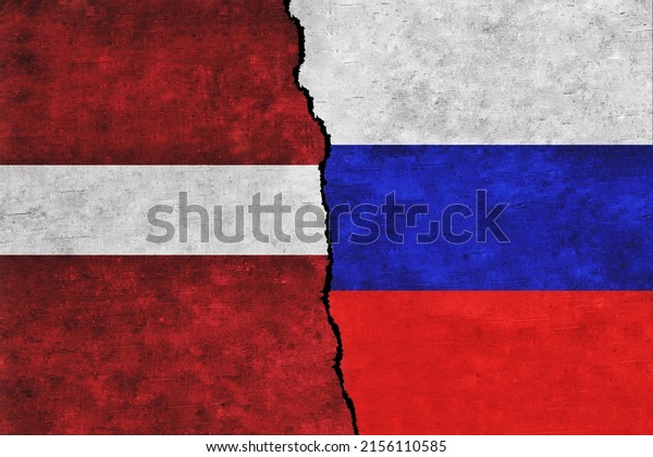 Russia and\
Latvia painted flags on a wall with a crack. Russia and Latvia\
conflict. Latvia and Russia flags\
together