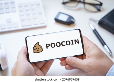 Russia Moscow 12.06.2021 Logo of Poocoin coin in mobile phone. Cryptocurrency token. Trading blockchain platform to buy,sell on decentralized exchange DEX. Digital money.Business,investing.