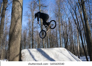 
Russia. Moscow - 22/02/20. A Cyclist Does A 360 Trick On A Springboard In Winter. Athlete Shows A Trick On A Bicycle.