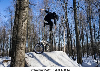 
Russia. Moscow - 22/02/20. A Cyclist Does A 360 Trick On A Springboard In Winter. Bmx Rider Shows A Trick On A Bicycle.