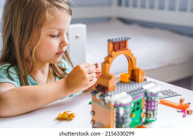 Russia, Moscow 25.07.2021 Girls, Sisters Play Kids Constructor, Build House Lego From Bricks, Blocks By Assembly Instrustions. Children Activity At Home. Intelligent Development Of Fine Motor Skills.