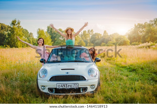 Russia, Moscow 27 July 2019 Best friends having\
fun celebrating car ride sunset group happy people outdoors\
vacation nature, friendship youth, concept journey, along with\
positive nostalgic\
emotions