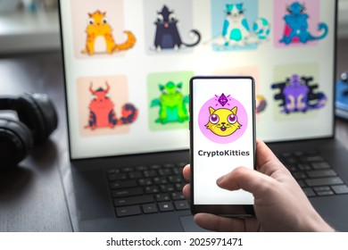 Russia Moscow 30.05.2021.Logo, Screenshot Of Blockchain Nft Ethereum Cryptocurrency Game Cryptokitties In Laptop Screen. Man Playing, Collecting Crypto Kitties. Earning Digital Money At Home.