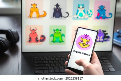 Russia Moscow 30.05.2021.Logo, Screenshot Of Blockchain Nft Ethereum Cryptocurrency Game Cryptokitties In Laptop Screen. Man Playing, Collecting Crypto Kitties. Earning Digital Money At Home.