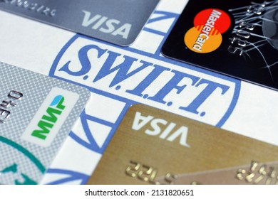 Russia, Moscow, 3.03.2022. Bank Cards Of Visa, Mastercard,MIR Payment Systems On A White Background With The SWIFT Logo