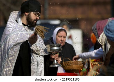 Russia, Moscow - April, 14, 2012: Priest Splashes Holy Water At Easter