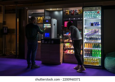 Russia, Moscow - February 11, 2022: People Buys Coffee And Food In Micro Market (unmanned Self Service Smart Store) In Night Office. Food Service Theme.