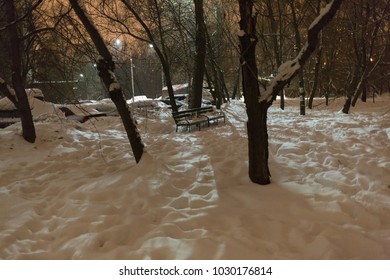 Russia, Moscow, February 21, 2018 Fillevsky Boulevard street, late evening, outdoors, snow, night, nature, lonely wooden bench in the park