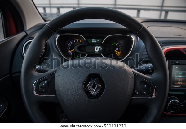 RUSSIA, MOSCOW - JULY 25, 2016.\
RENAULT KAPTUR / CAPTUR interior view. Compact crossover SUV.\
Renault close up logo on the steering wheel. Renault car logo\
bage.