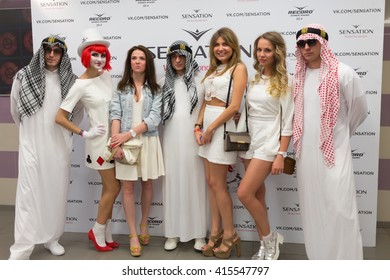 RUSSIA, MOSCOW - JUN 12, 2015: Group Of Young People In White Clothes Stands In Front Of Poster Of Sensation Wicked Wonderland At Olympiysky Sports Complex.