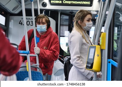 Russia Moscow June 2020. Urban Public Transport. People In Medical Masks Ride A Bus During The Coronavirus Epidemic In Russia. Color