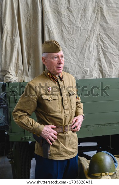 Russia, Moscow, March\
8, 2020. Exhibition of vintage cars. An elderly man in the uniform\
of a Soviet officer.