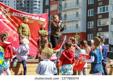 Russia, Moscow, May 9, 2018: Victory Day. Caucasian Children Dance At The Stage With A Concert. Playing Kids In Patriotic Clothes At The Parade On May 9 