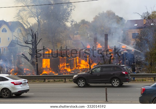 Russia, Moscow, Mytishchi, October 1, 2014 - the
Yaroslavl highway, M8, work to expand the road, the house is
burning, the fire are fire engines, firefighters are working on the
road going cars.