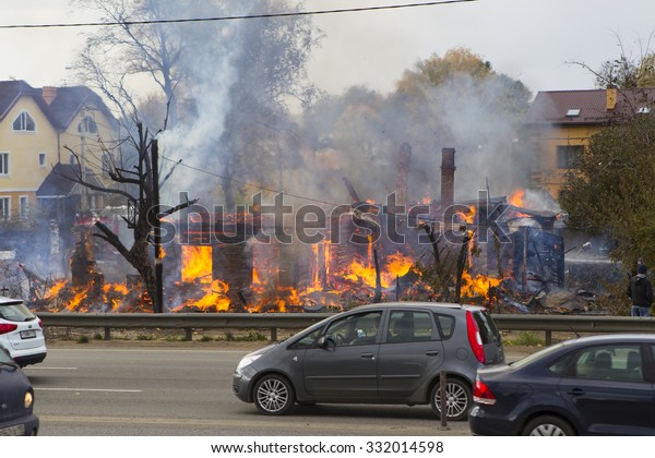 Russia, Moscow, Mytishchi, October 1, 2014 - the\
Yaroslavl highway, M8, work to expand the road, the house is\
burning, the fire are fire engines, firefighters are working on the\
road going cars.