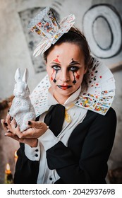 Russia Moscow October 30, 2019 Young Woman With Spooky Makeup Wearing Queen Of Hearts Costume With Card Collar With A Rabbitvisiting Night Halloween Party.