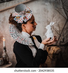 Russia Moscow October 30, 2019 Young Woman With Spooky Makeup Wearing Queen Of Hearts Costume With Card Collar With A Rabbitvisiting Night Halloween Party.