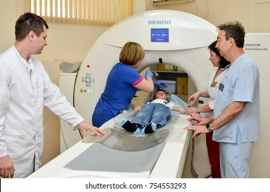 Russia, Moscow Region, Dmitrov, City Clinical Hospital, June 9, 2017. A Team Of Doctors Conducts Magnetic Resonance Therapy For A Small Child On Special Equipment...