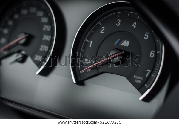 RUSSIA, MOSCOW - SEPTEMBER 24, 2016. BMW\
M2 Performance Pack interior view. Black sport car dashboard view.\
BMW close-up logo. Symbol of BMW M on\
speedometer.
