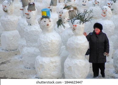 Russia. Moscow. A Woman In A Fur Hat Walks Among Snowmen On A Frosty Winter Day - January 23, 2010