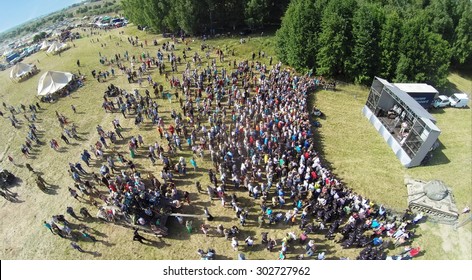 RUSSIA, NELIDOVO -?? JUL 12, 2014: Crowd Of People Listen Concert During Reconstruction Battlefield At Second World War. Aerial View. (Photo With Noise From Action Camera)