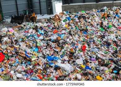 Russia, Nizhny Novgorod 01/21/2019 /A large pile of waste at a garbage recycling plant. Bulldozer unloads raw materials for subsequent sorting