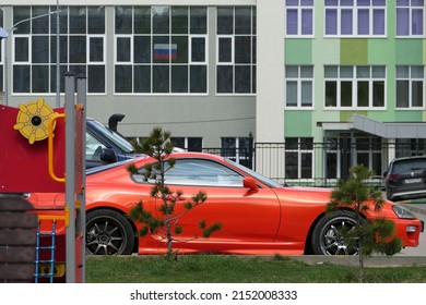 Russia, Nizhny Novgorod, Gagarin Avenue 101, 04.28.2022. Red Car In The Parking Lot In The Courtyard Of A Modern Residential Complex.