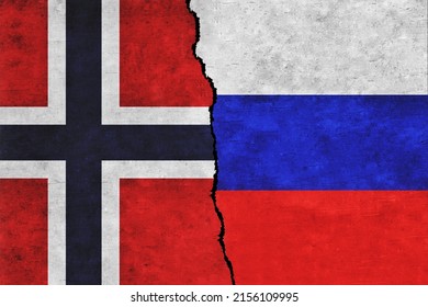 Russia and Norway painted flags on a wall with a crack. Russia and Norway conflict. Norway and Russia flags together