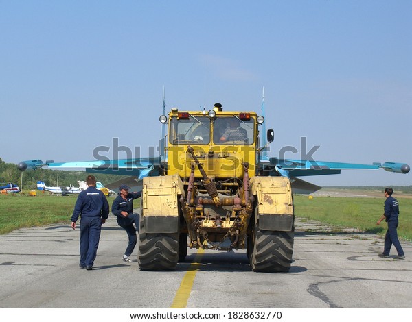Russia, Novosibirsk
01.01.2005: technicians tow a military plane to the airfield
tractor carries a
fighter