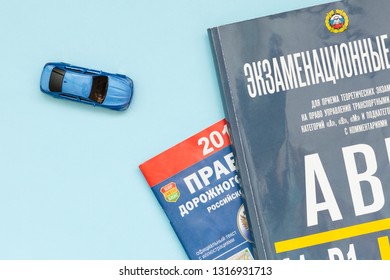 Russia, Novosibirsk - Febrary 18, 2019: Russian Highway Code Book And Model Car. Book Of Traffic Rules And Law. Preparation For Exam Or Driving Test Concept. Driving School