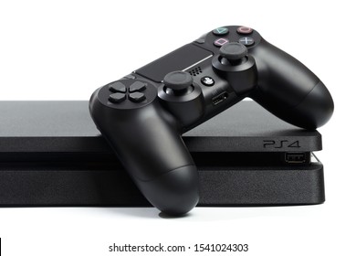Russia, OKTOBER 24 2019: Sony PlayStation 4 game console and controller, closeup on a white background.